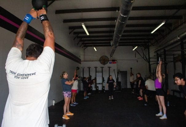 The group is holding weights above their heads